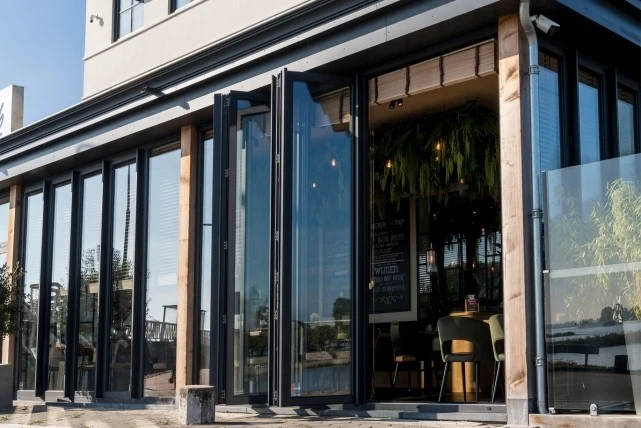 restaurant entrance with bifold crittall doors and outdoor seating