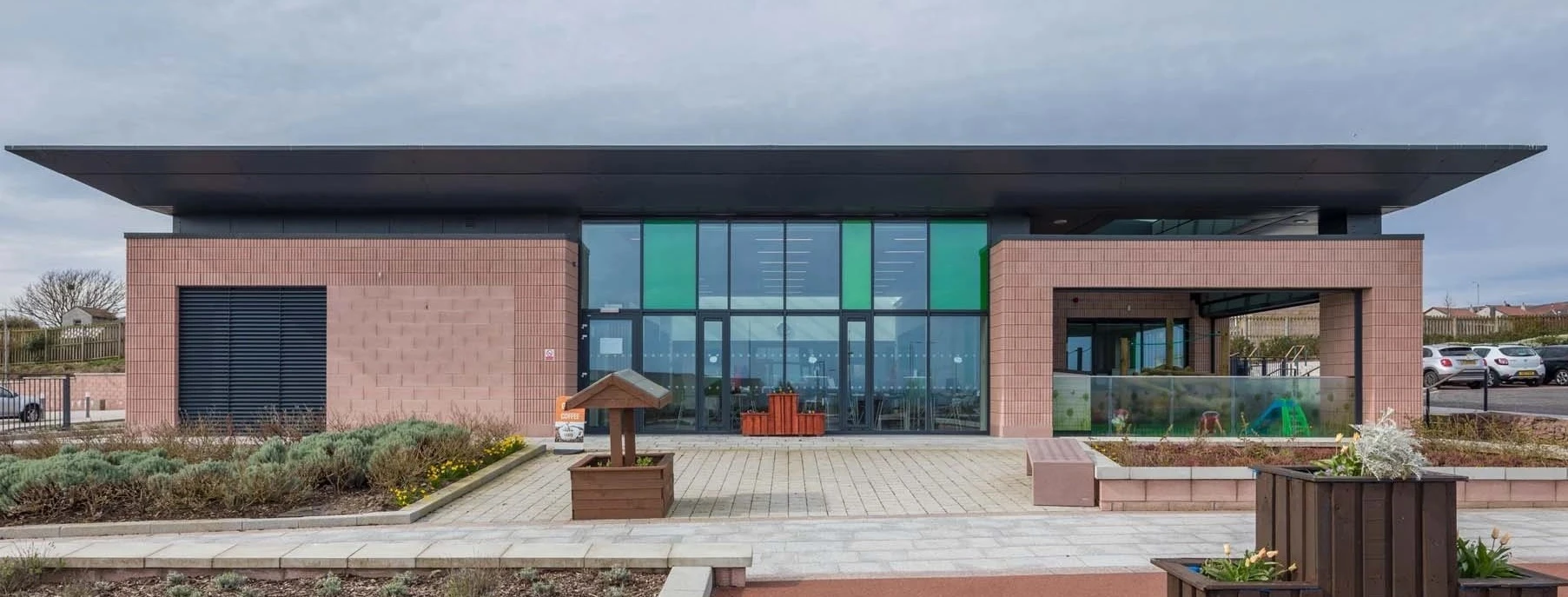modern office building with steel windows and doors and green glass panels
