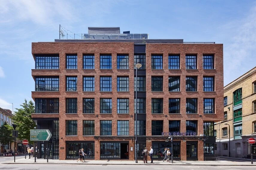 apartment building facade featuring crittall style windows and brickwork