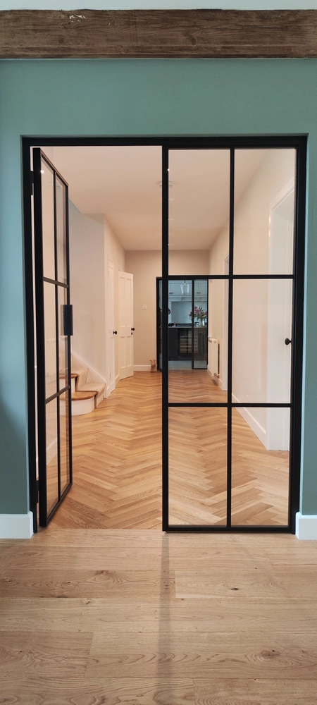 corridor with steel crittall doors and a wooden floor