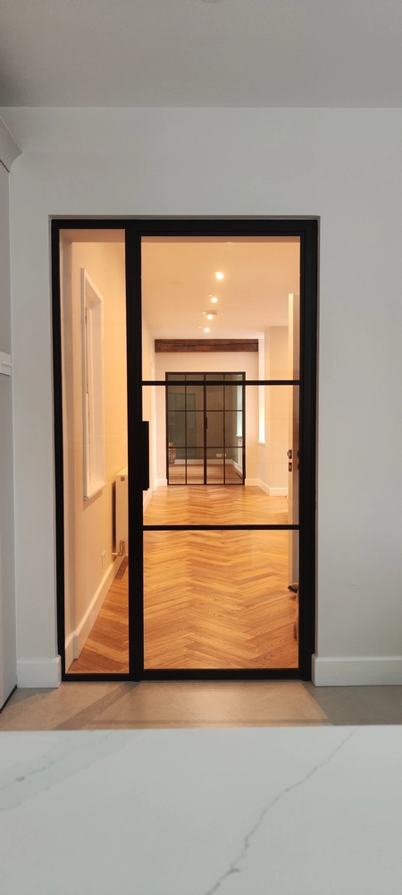corridor with internal crittall doors and warm lighting
