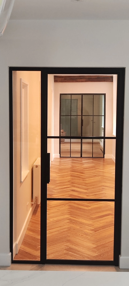 entryway with bifold crittall doors and a minimalist design
