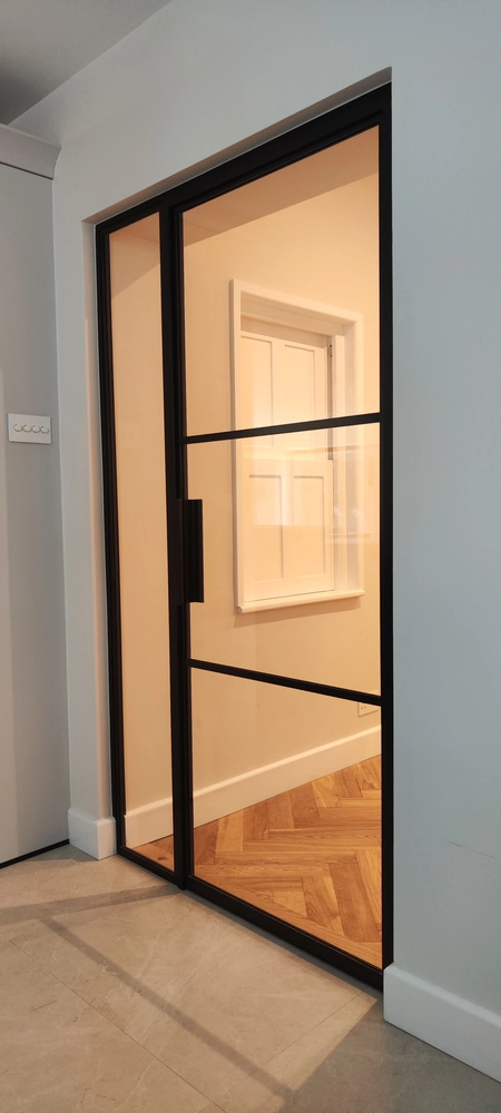 entryway with fire rated crittall doors and a minimalist design