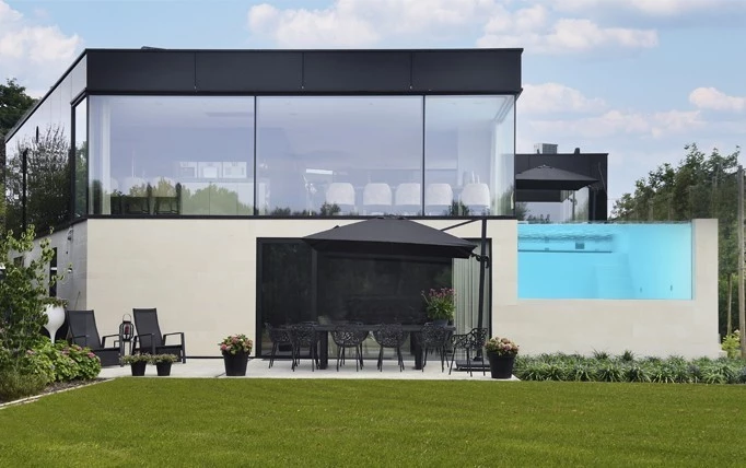 luxury villa featuring steel windows and doors and a covered patio