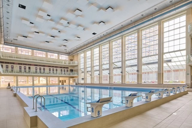 swimming pool area with floor-to-ceiling steel windows and doors