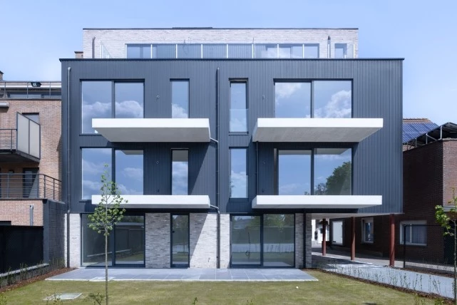 modern residential complex featuring steel windows and doors and blue panels