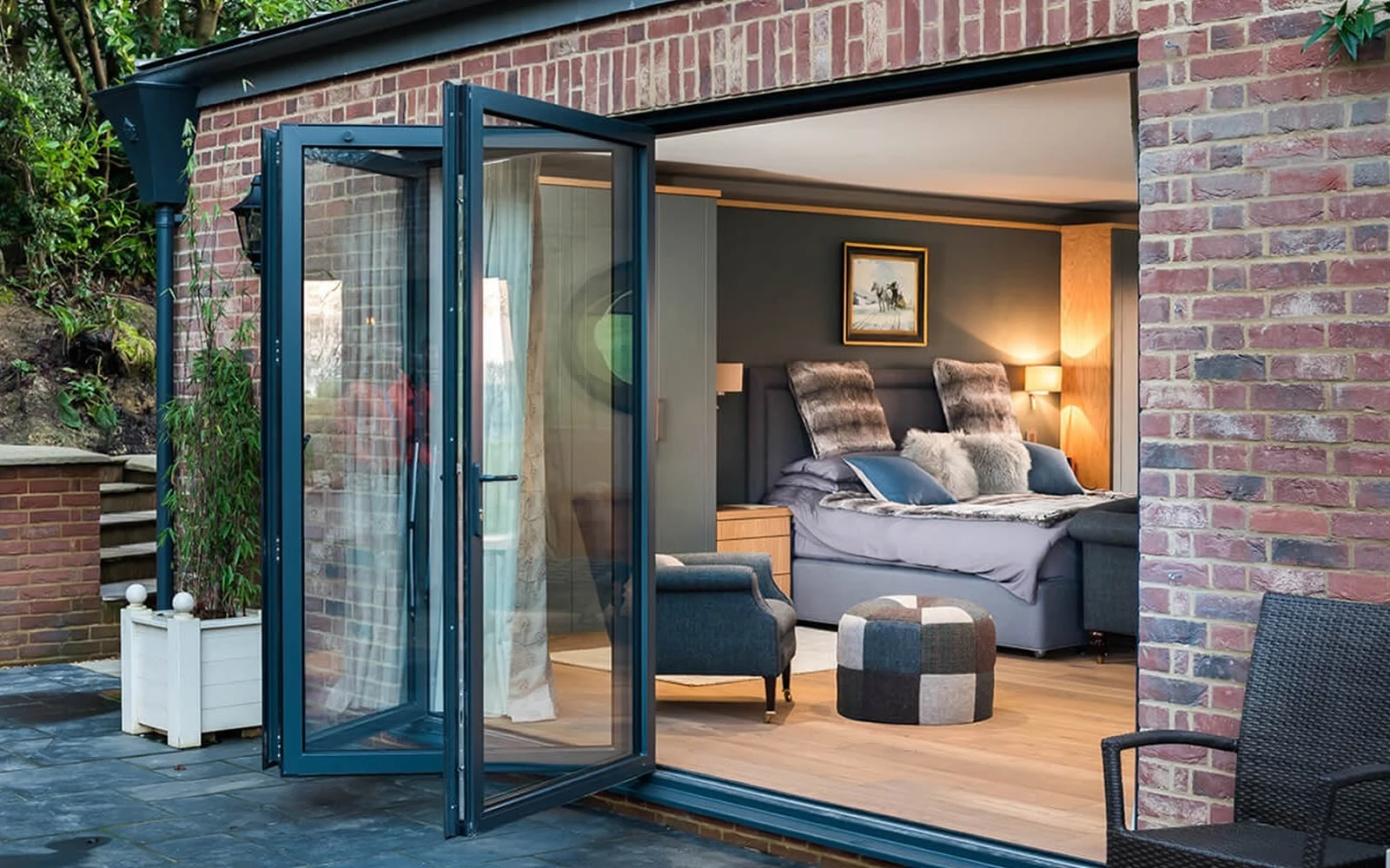 bedroom with crittall bifold doors external and a view to the patio