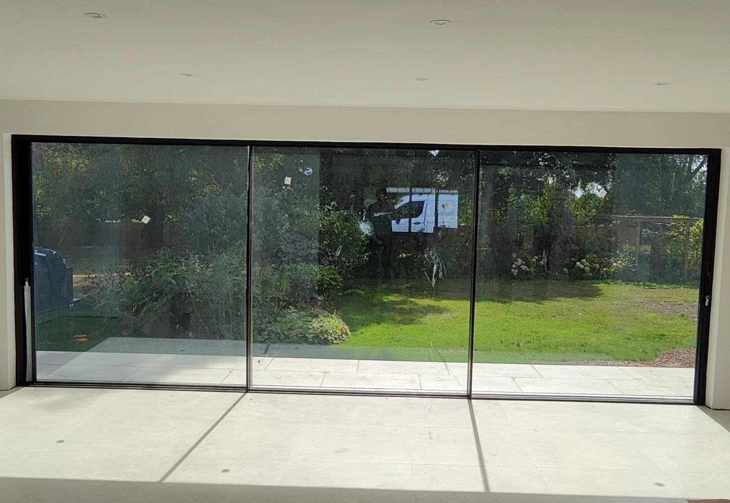 living room with floor-to-ceiling metal doors and windows and a terrace view