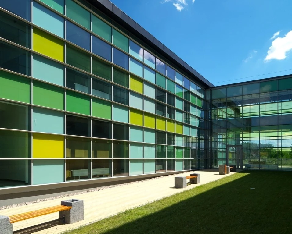 office building with metal doors and windows and green glass panels