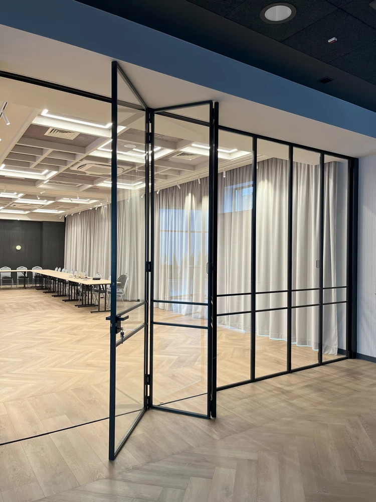 office space divided by crittall style bifold doors and glass partitions