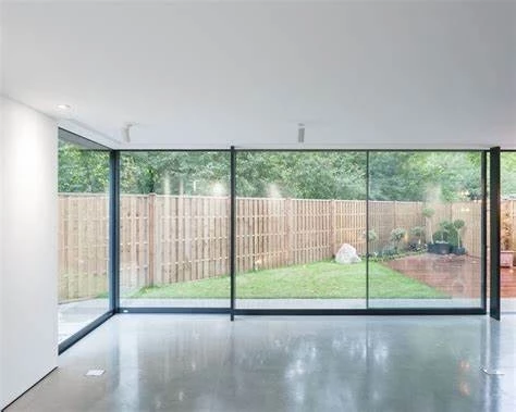 sunroom with large metal windows and doors and polished concrete floor