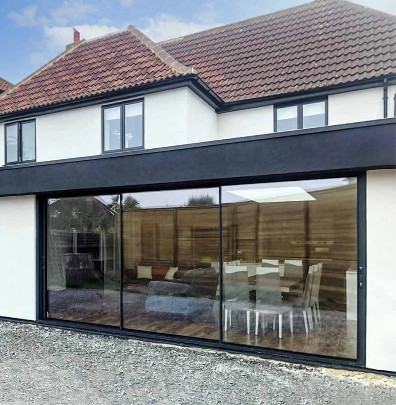 house facade featuring metal doors and windows and large glass panels