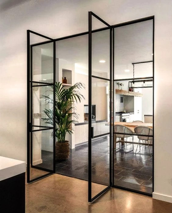 home office with metal windows and doors and a potted plant