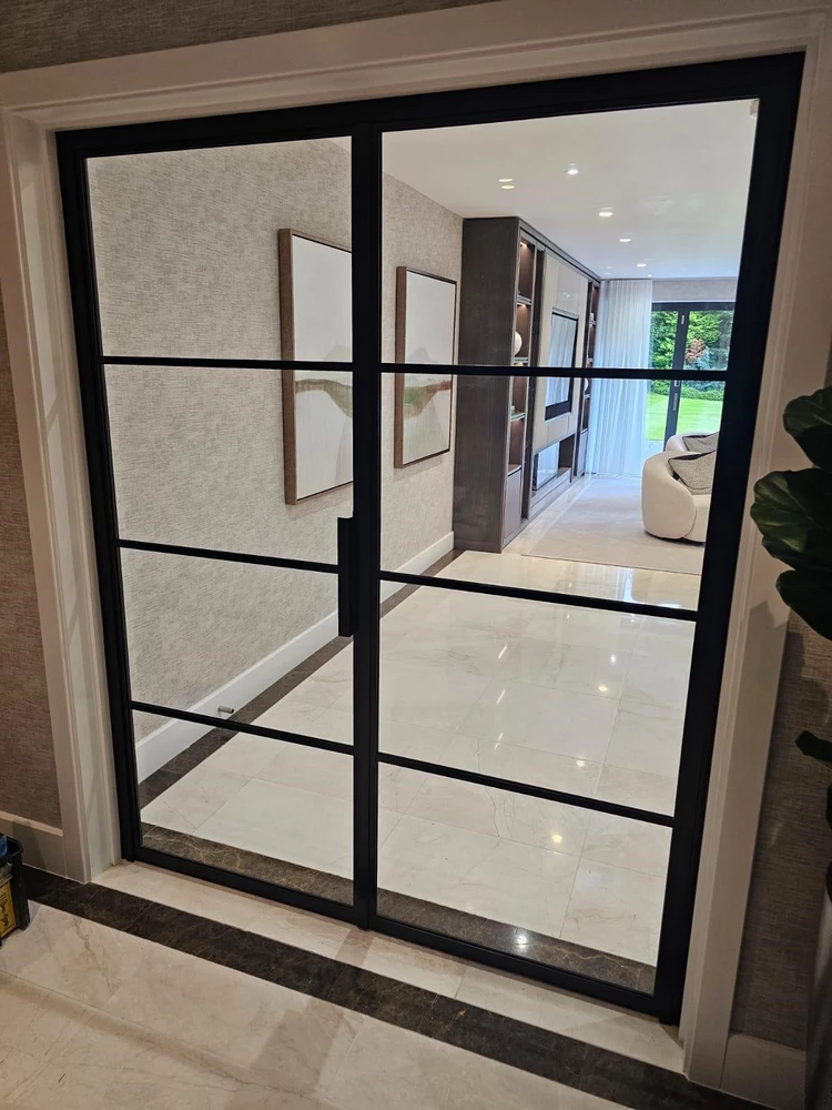 office space with internal crittall doors and a floral arrangement
