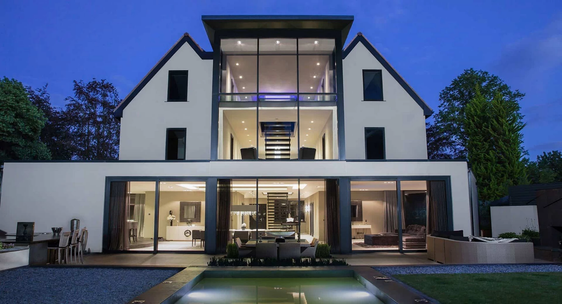 modern house facade with large steel windows and doors and balcony lighting