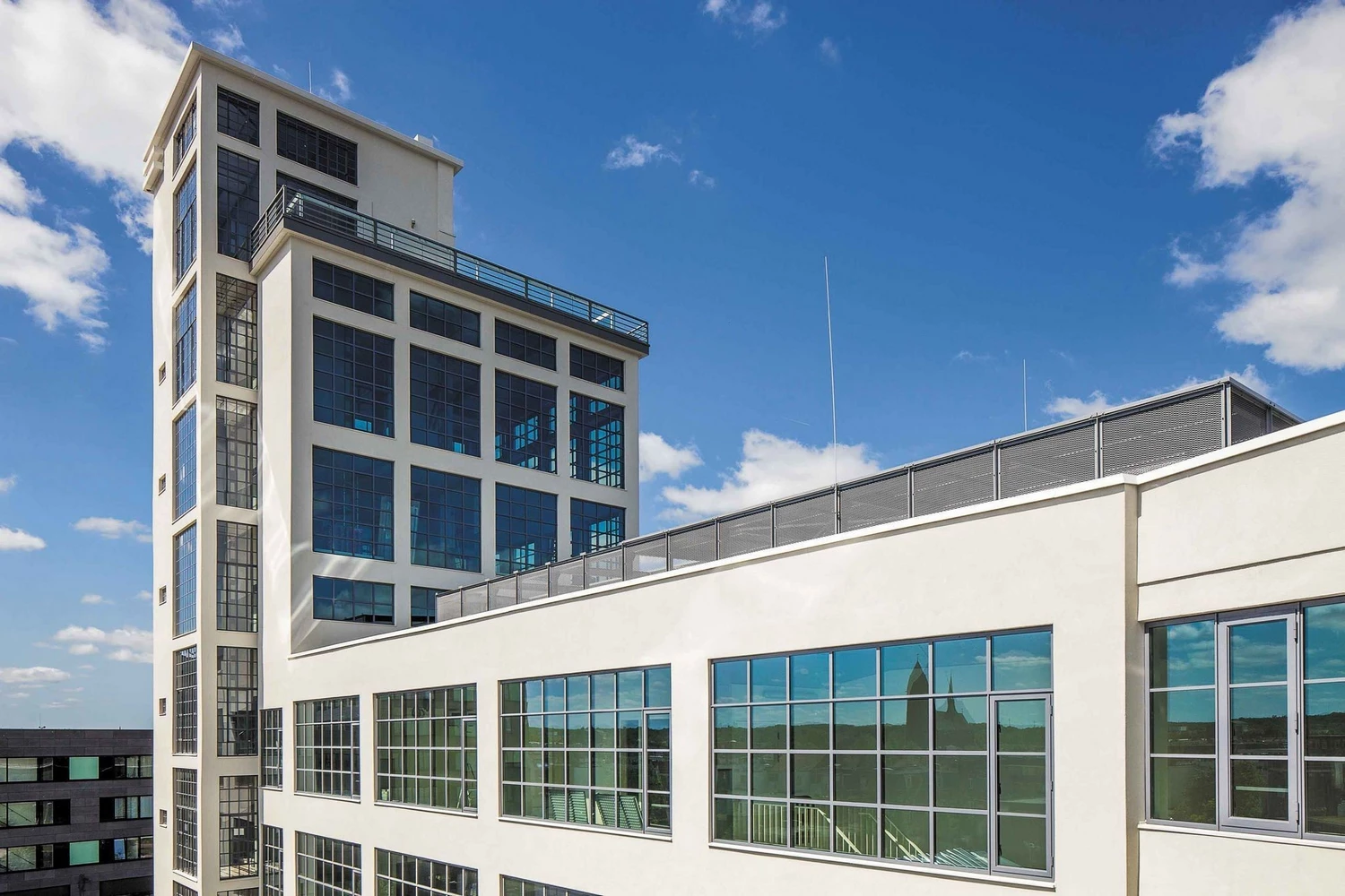 modern office building with steel windows and doors and a white facade