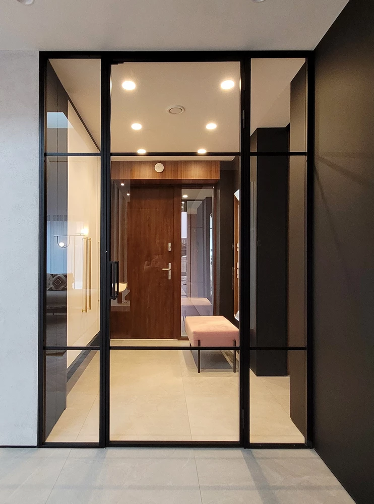 hallway with fire rated crittall doors and a pink bench