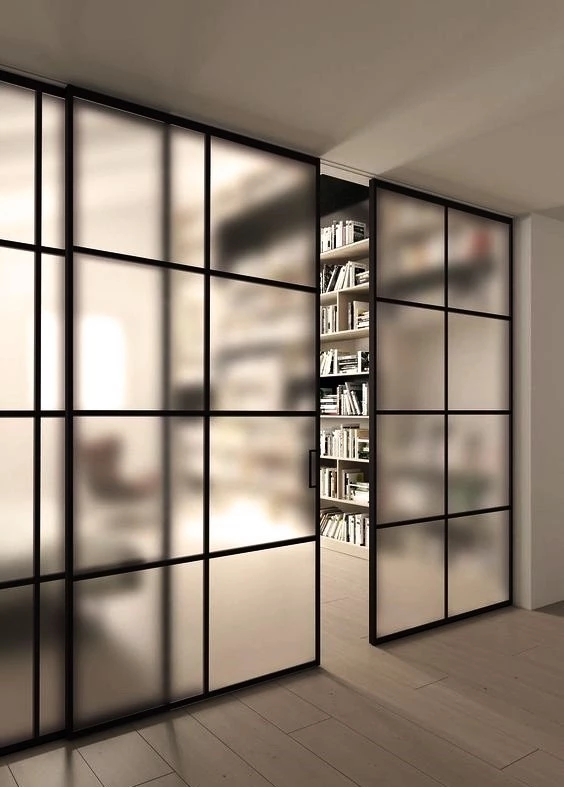 home library with internal crittall style doors and glass shelving