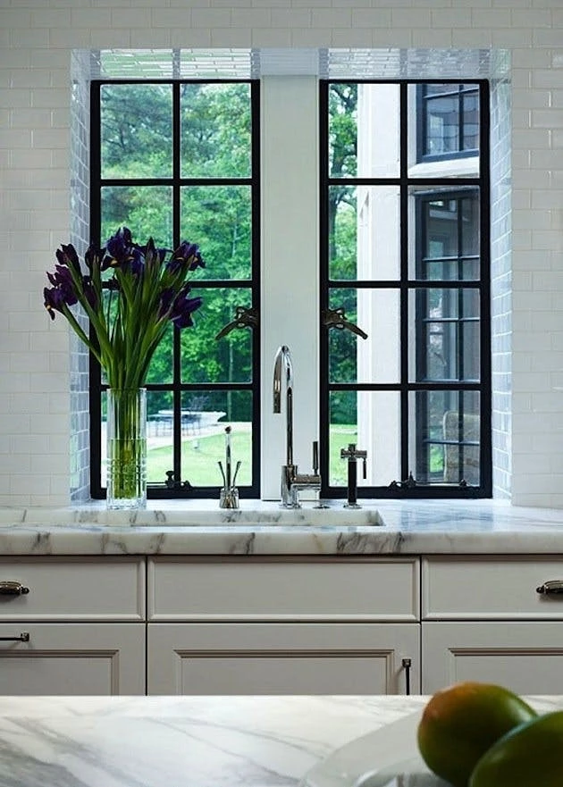kitchen sink area with crittall style windows and garden view