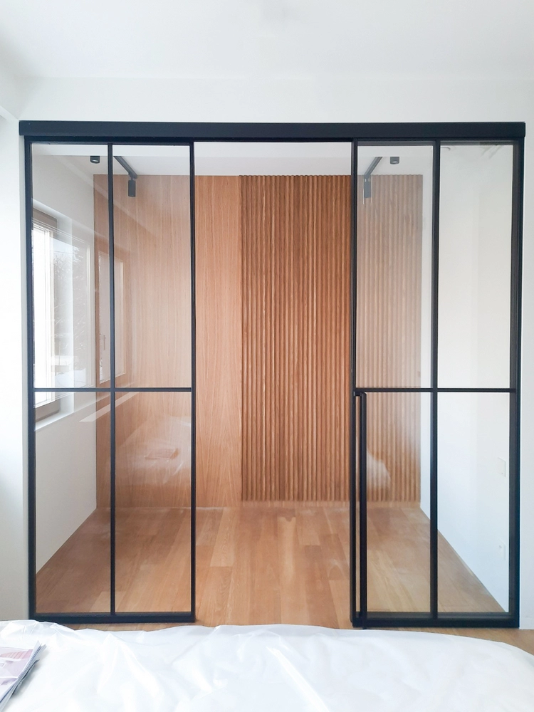 hallway with crittall style doors and wood panel accents