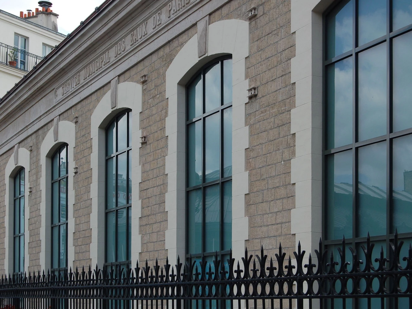 historic building facade with arched steel windows and doors in a crittall style