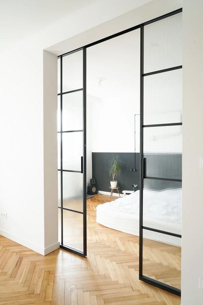 living room with crittall style doors and a potted plant