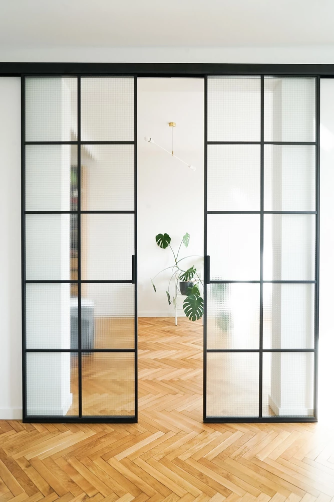modern kitchen with crittall bifold doors and brown barstools