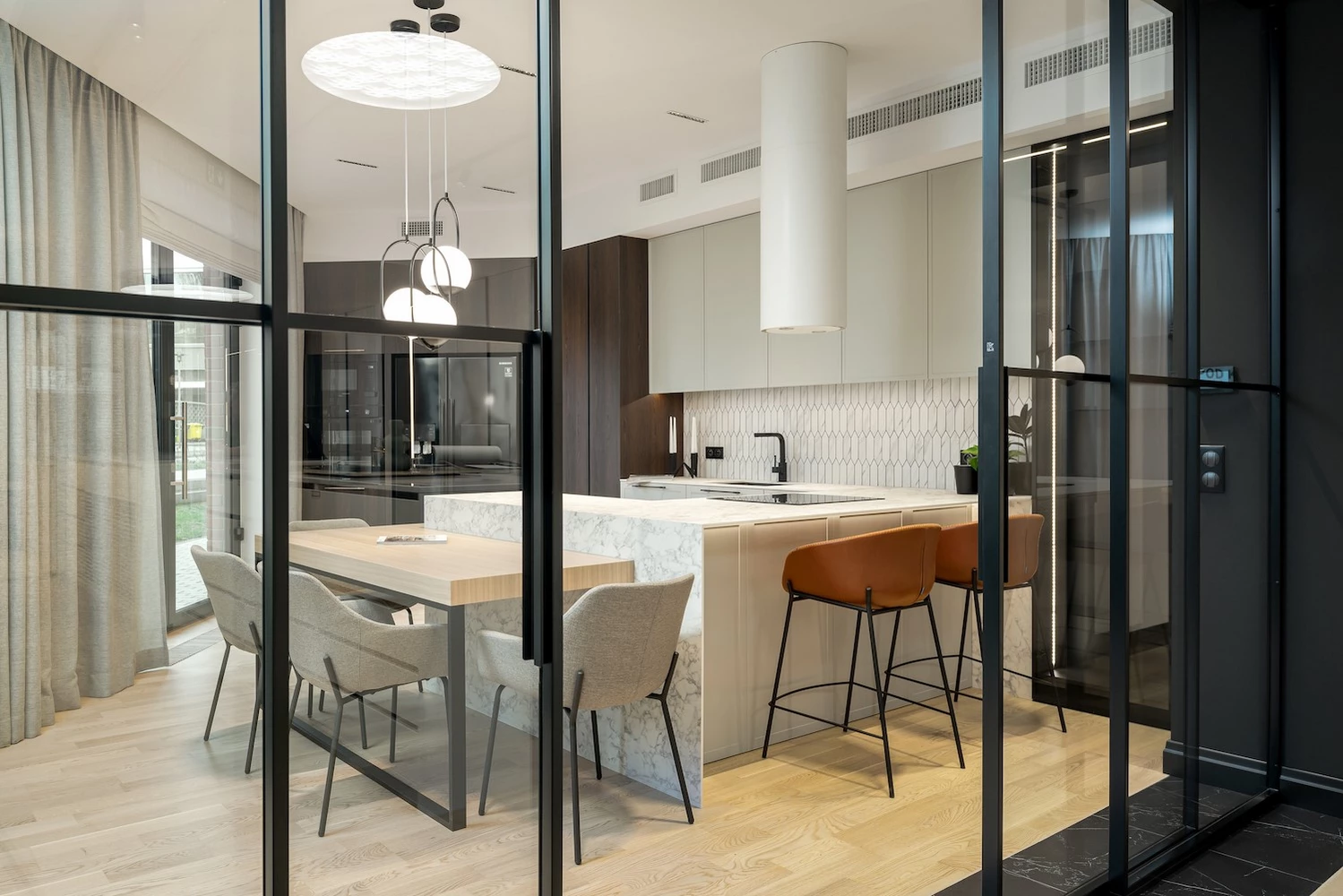dining area separated by metal windows and doors in a crittall style