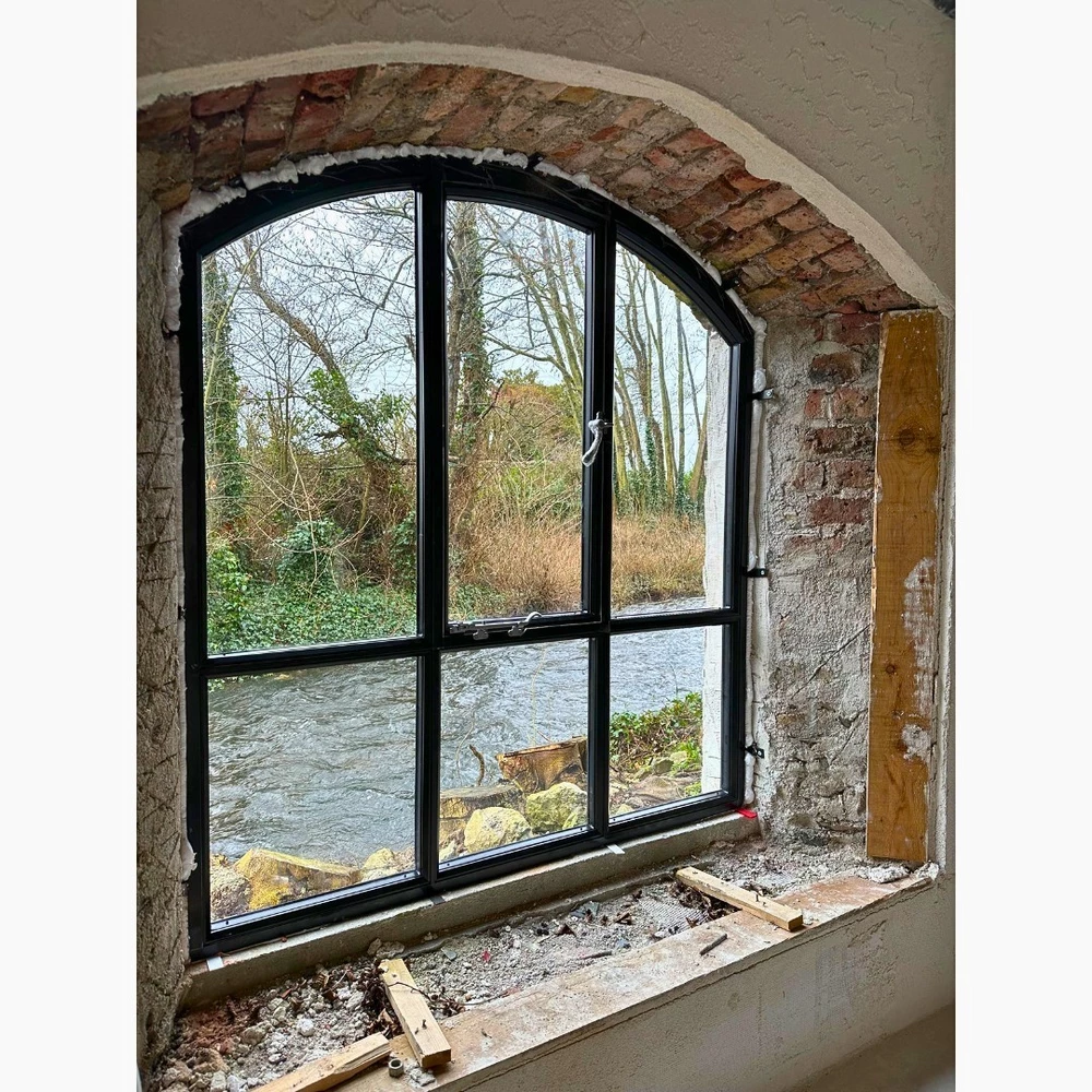 rustic interior with arched crittall style windows and exposed brick