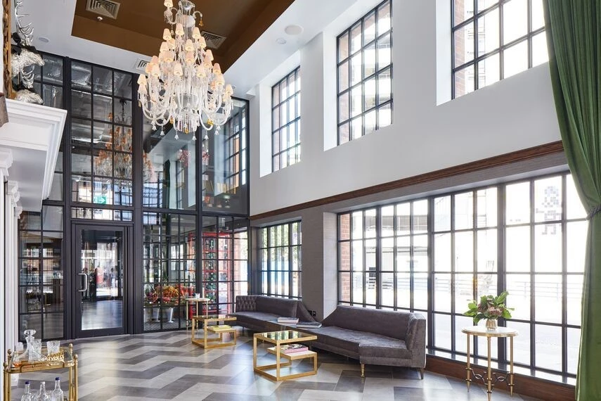 hotel lobby with floor-to-ceiling steel windows and doors