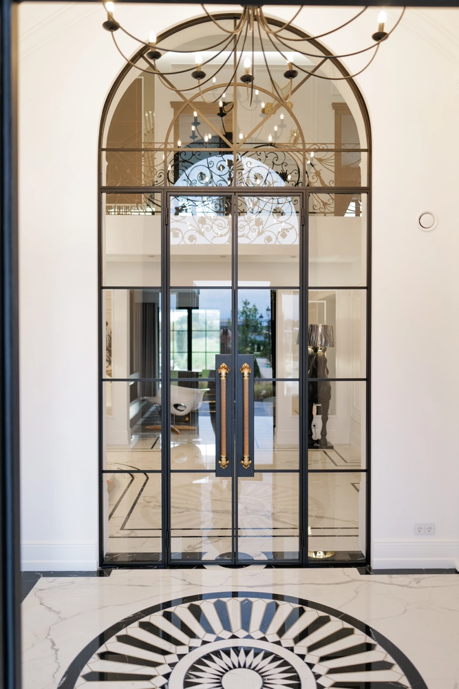 hallway with gold steel doors and a blue accent wall