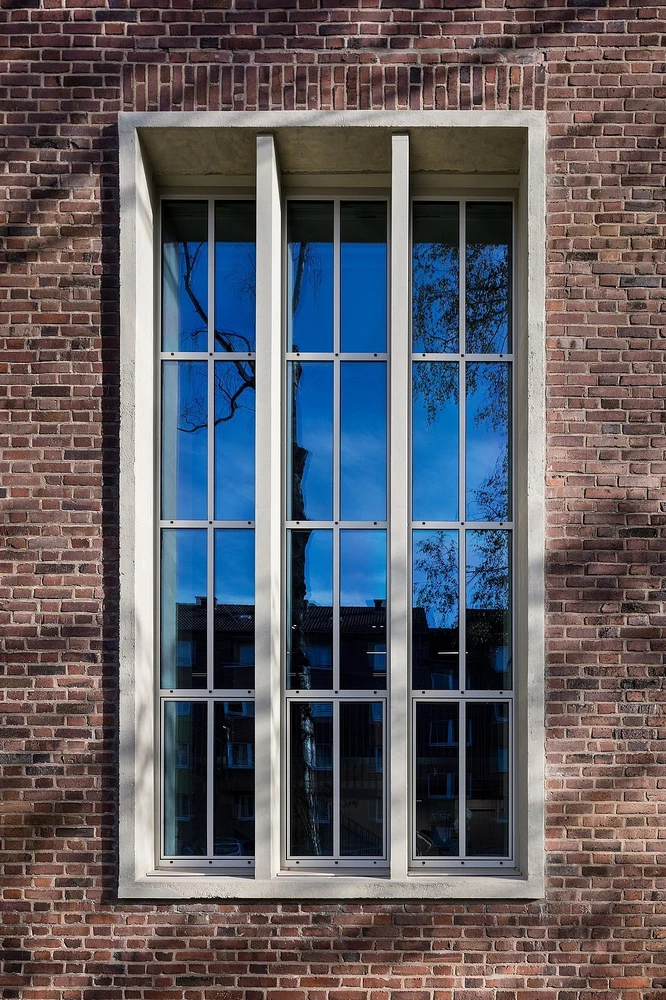 office tower with black steel doors and vertical glass panels