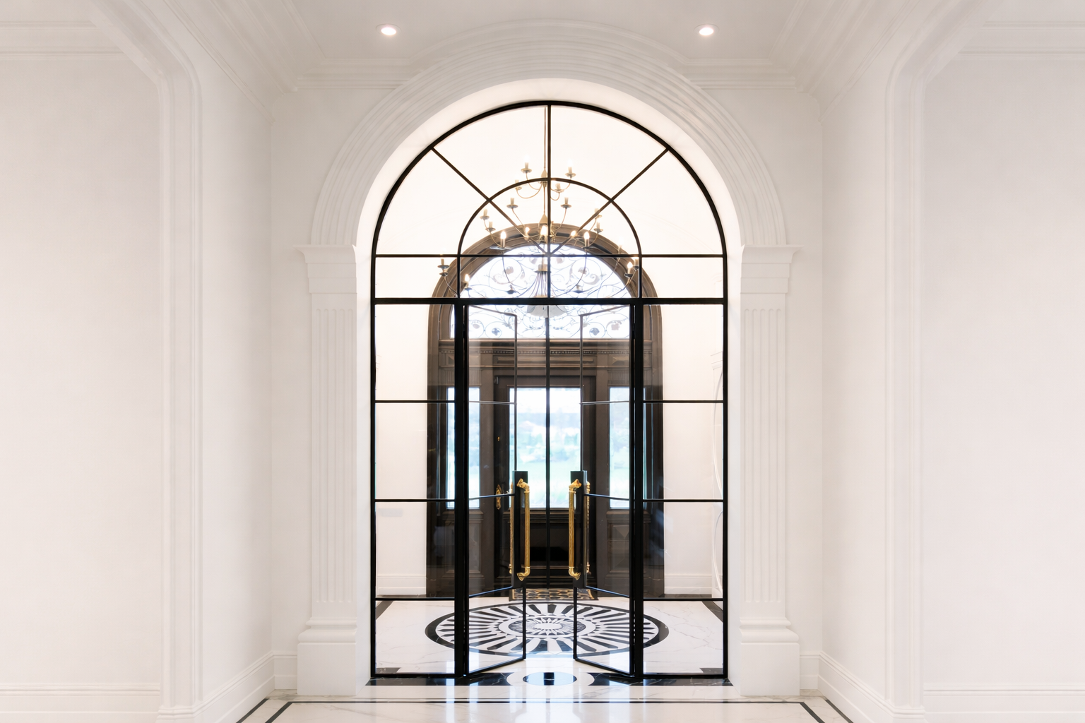 Beautiful arched door in grand hallway with gold handles